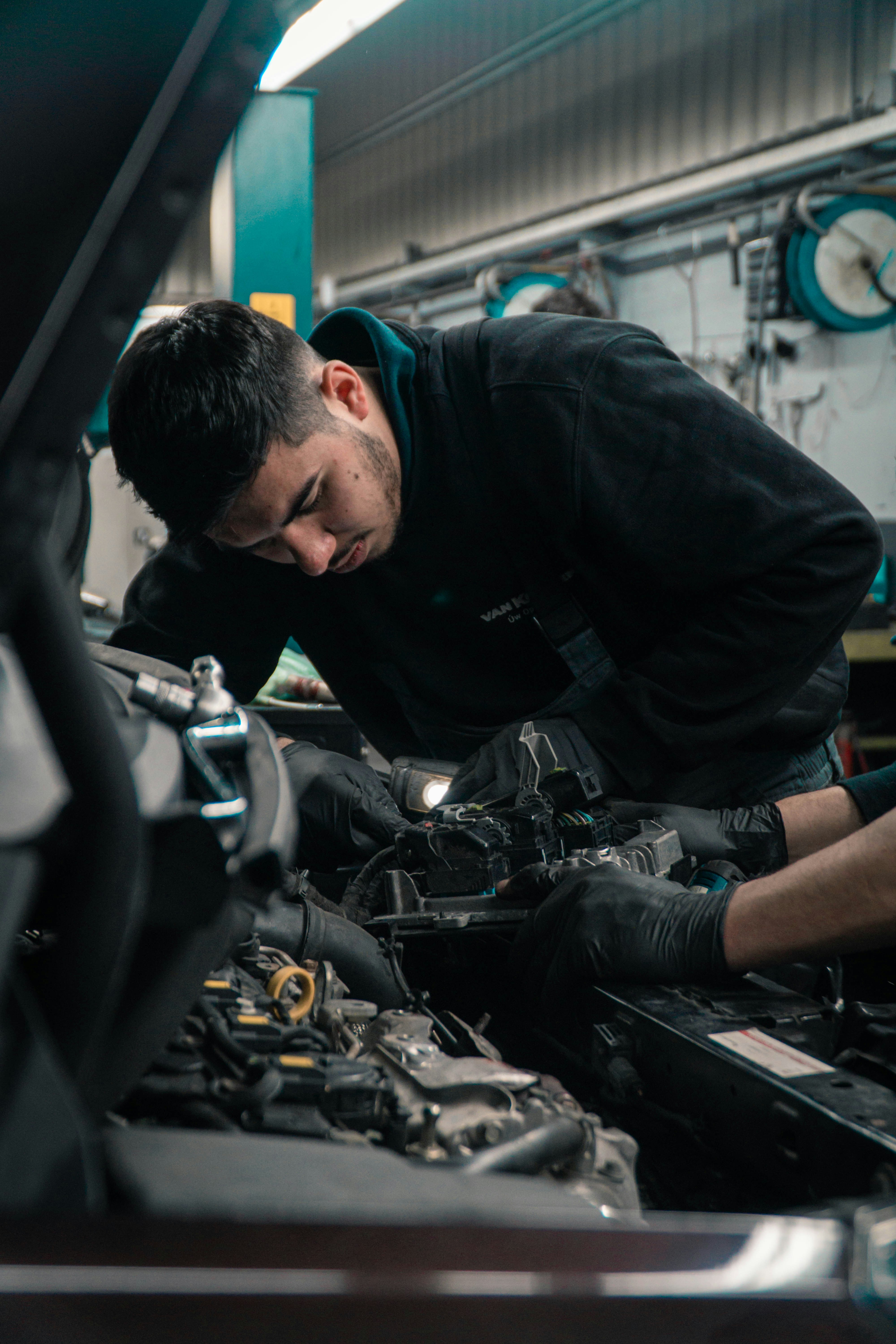 Technician performing vehicle diagnostics and inspection